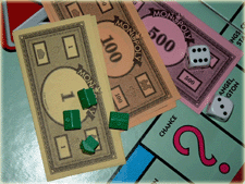 Monopoly board: Buy or Rent a home.